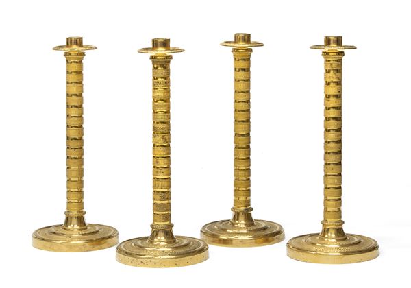 QUATTRO CANDELIERI IN BRONZO DORATO, INIZI XIX SECOLO